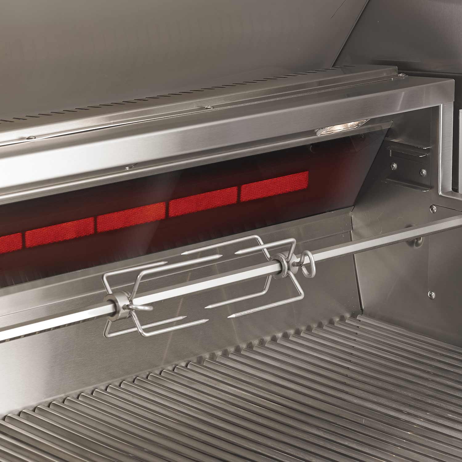 Open grill firebox showing warming rack and red infrared sear zone