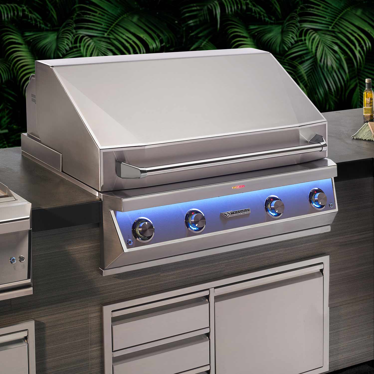 Gas grill with open hood, control panel, and side storage doors