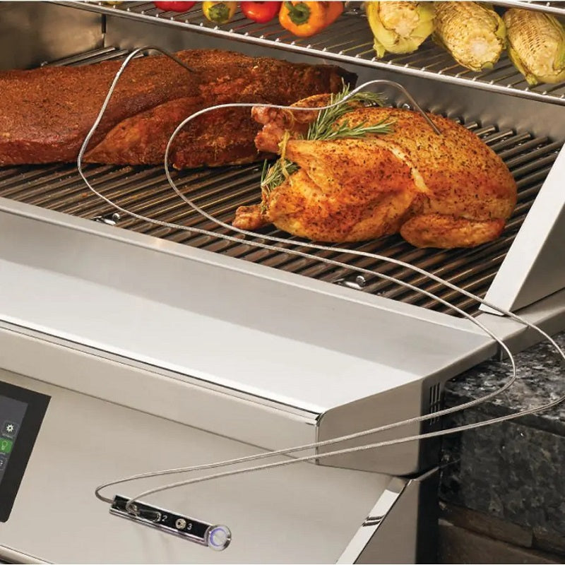 Pellet smoker grill with whole chicken and vegetables on open cooking grate