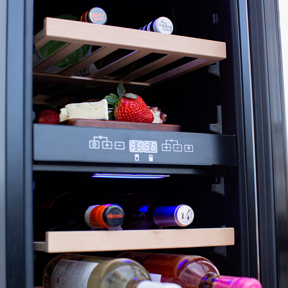 Wine cooler interior with wooden shelves, bottles, and blue LED display panel