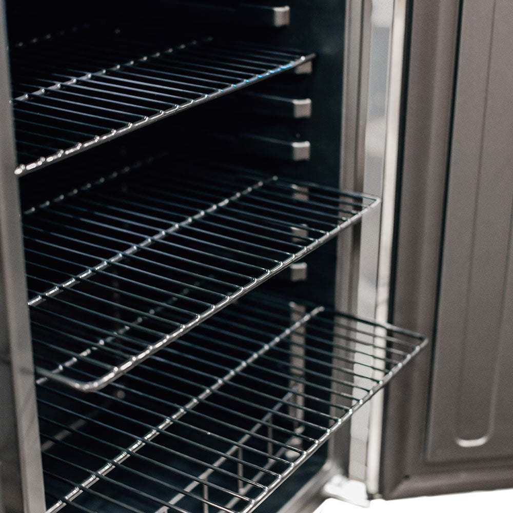 Outdoor mini fridge interior with wire rack shelves and door side wall