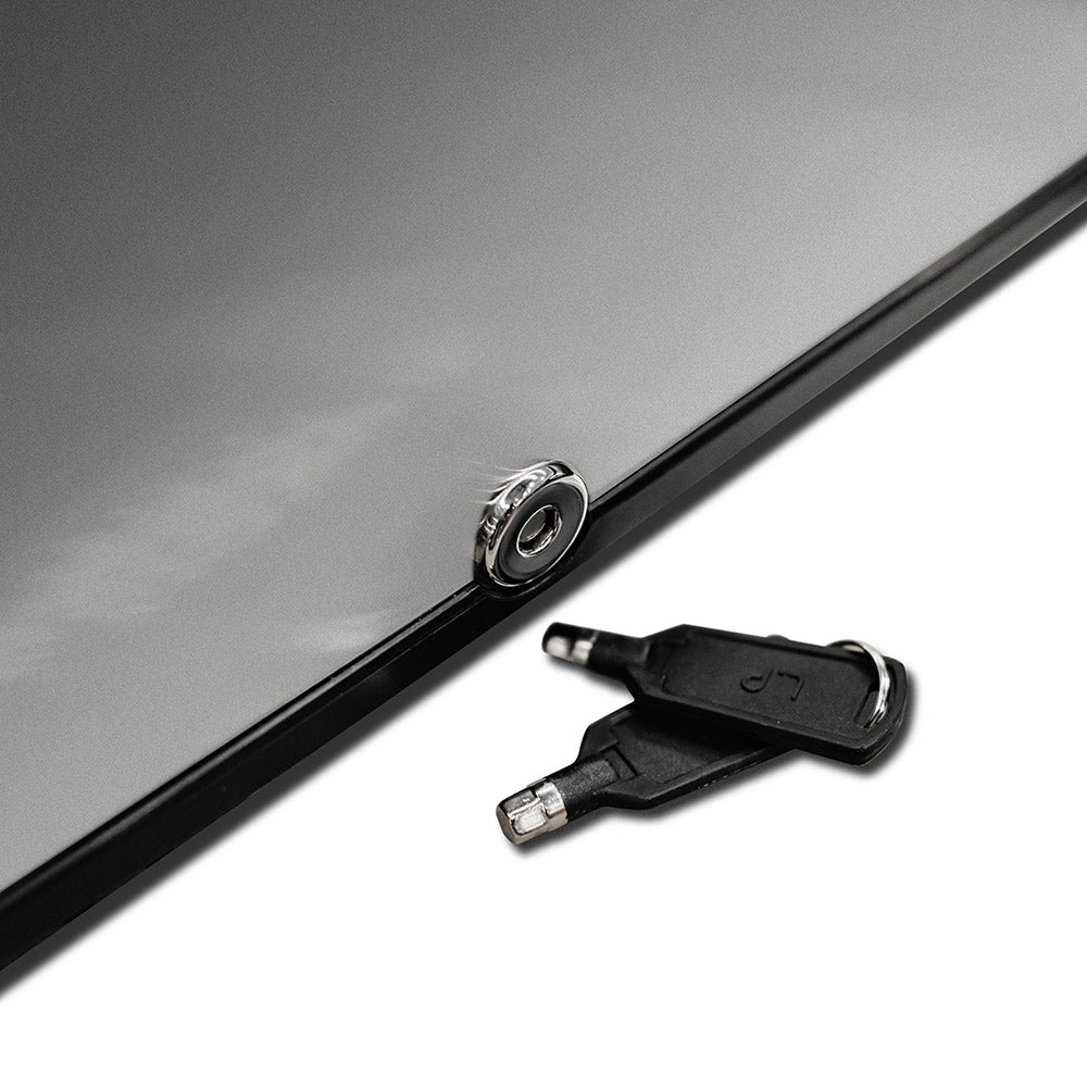 Reversible fridge lock detail with key inserted on dark door trim.