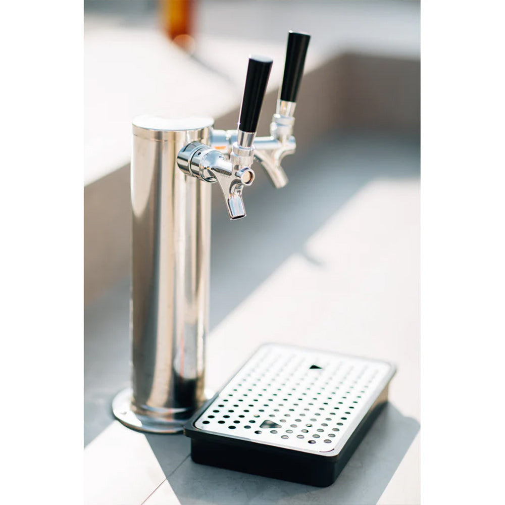 Dual-tap beer faucet with drip tray on a stainless kegerator column