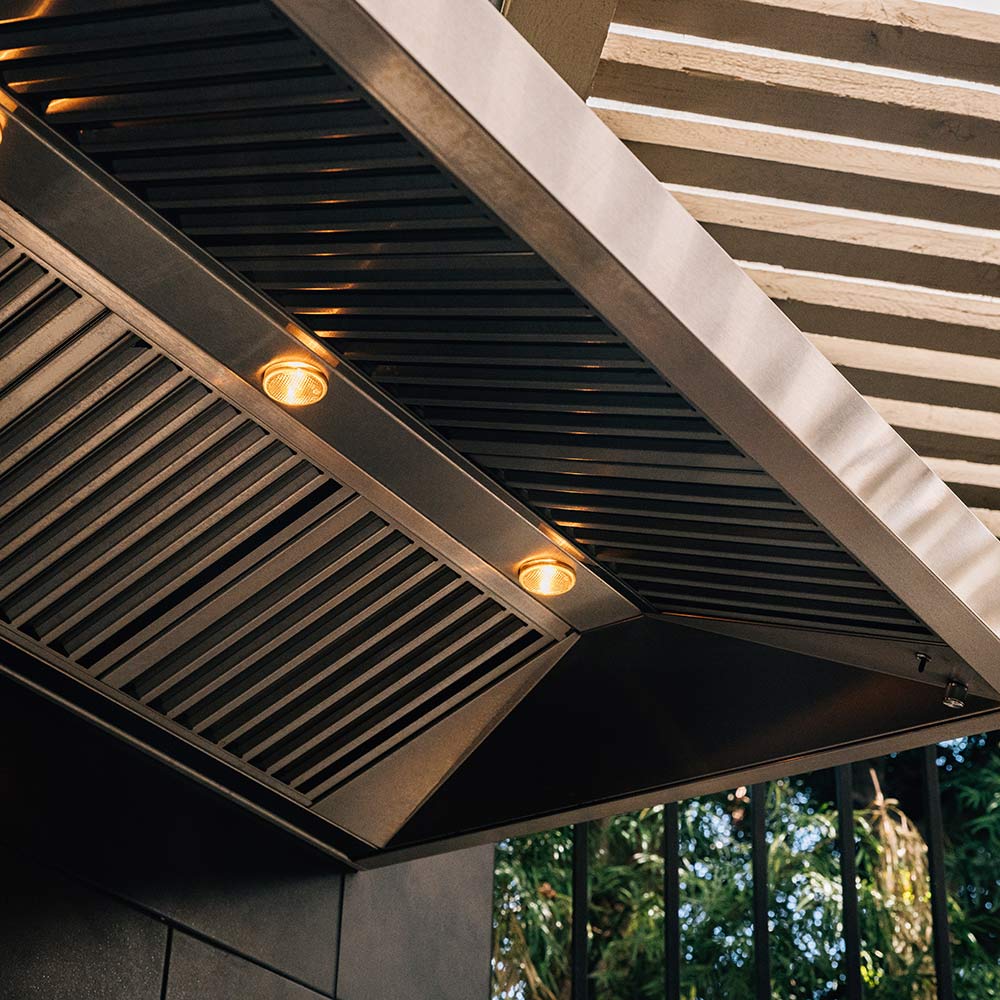 Outdoor vented hood underside with metal grille and built-in indicator lights