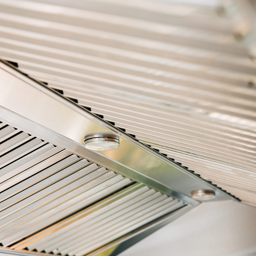 Outdoor vent hood vent grille with circular blower opening on stainless steel panel