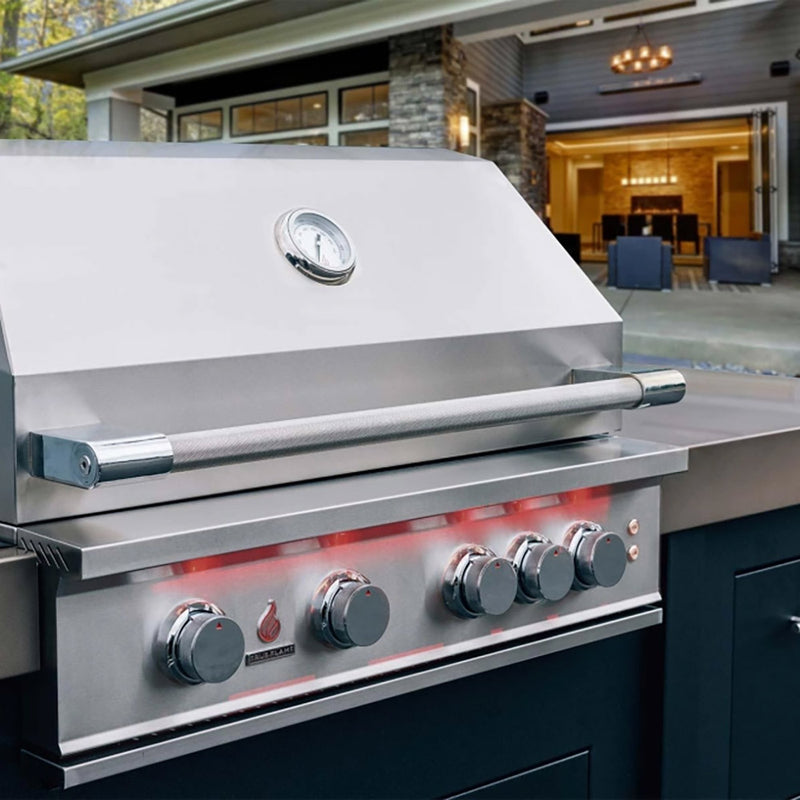 Stainless gas grill with closed hood, side shelves, and front control knobs