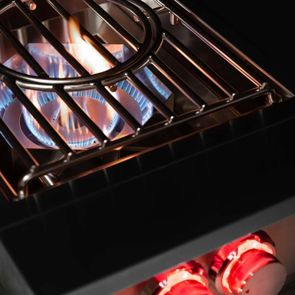 Power burner with blue flames visible through black grate