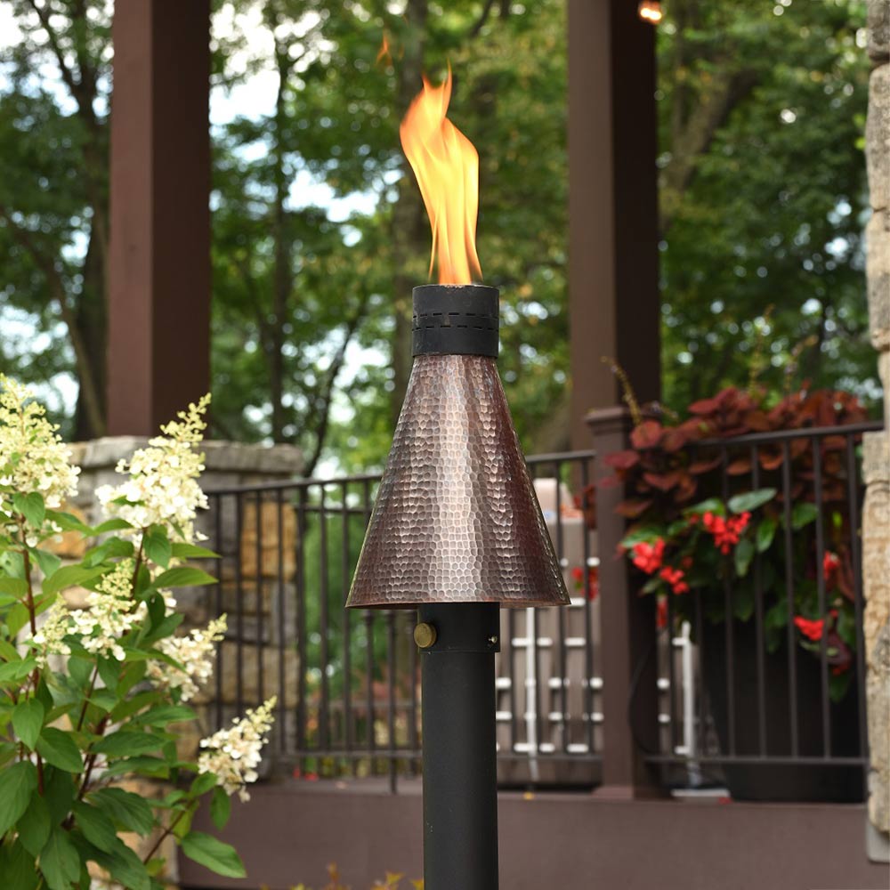Outdoor match-light torch with flame, hammered copper top and black post