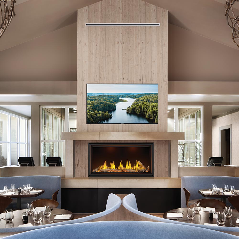 Linear gas fireplace with glowing logs and yellow flames in a modern living area