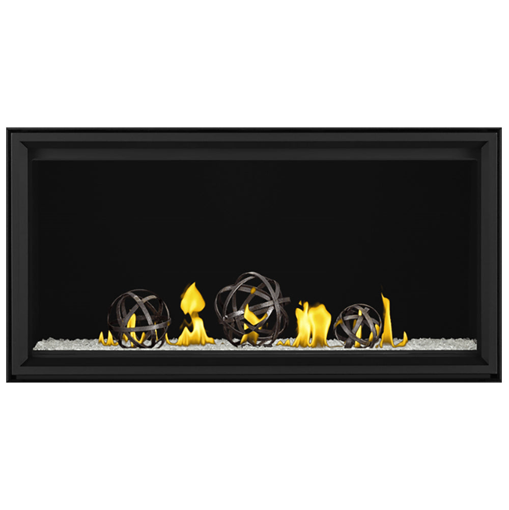 Black linear direct vent gas fireplace with four burner flames over light ember bed
