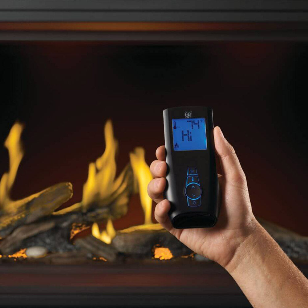 Gas fireplace with handheld remote shown in front of luminous logs and yellow flames