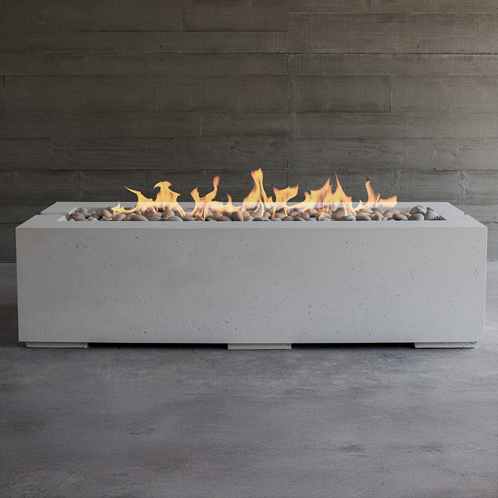 Lightweight concrete gas fire pit with open flames and light gray stones
