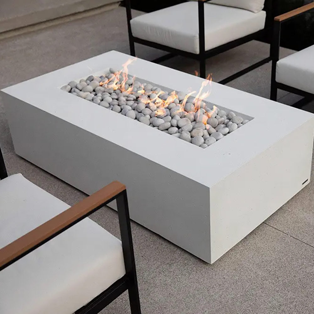 Lightweight concrete gas fire pit with flames and gray pebble stones, rectangular firebox