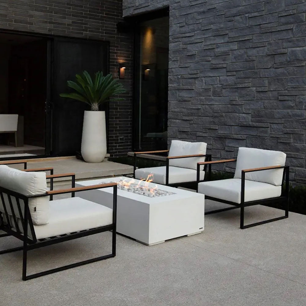 Lightweight concrete gas fire pit with visible flames and gray pebble firebed