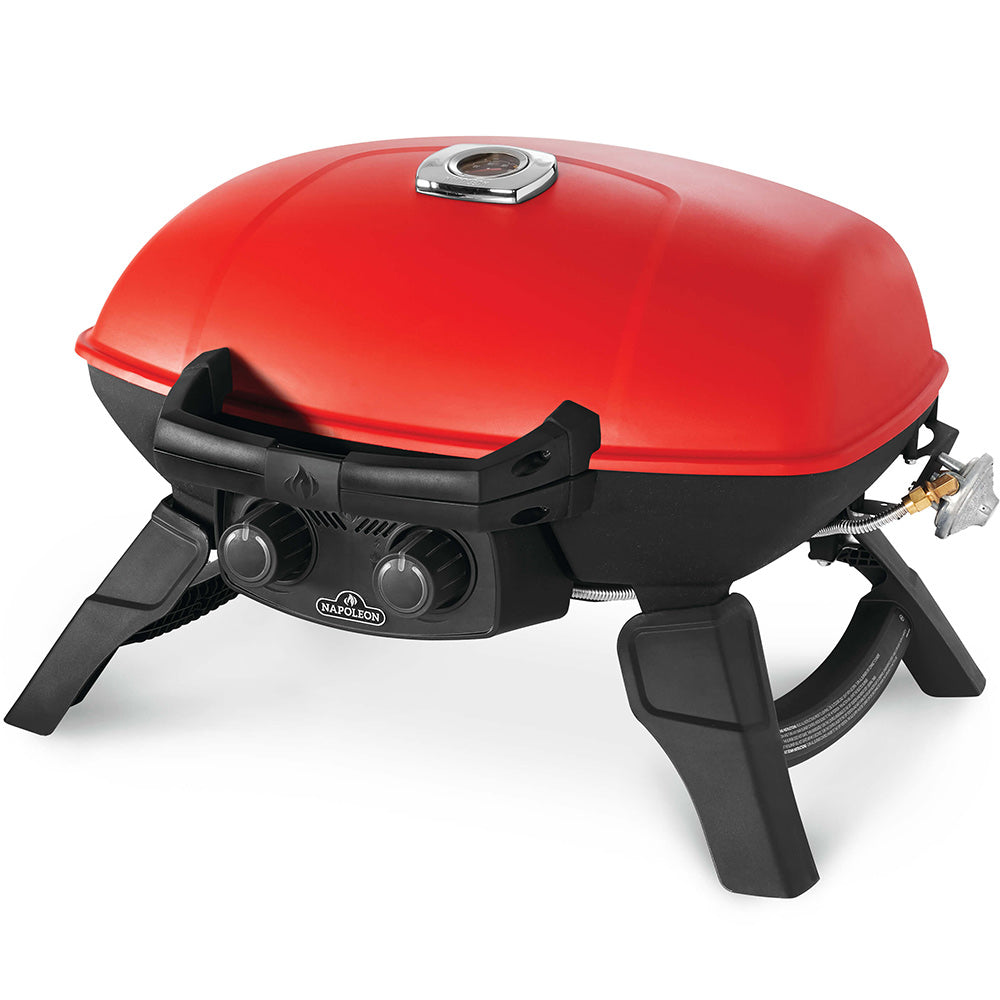 Red portable gas grill with black side shelves, front knobs, and three support legs