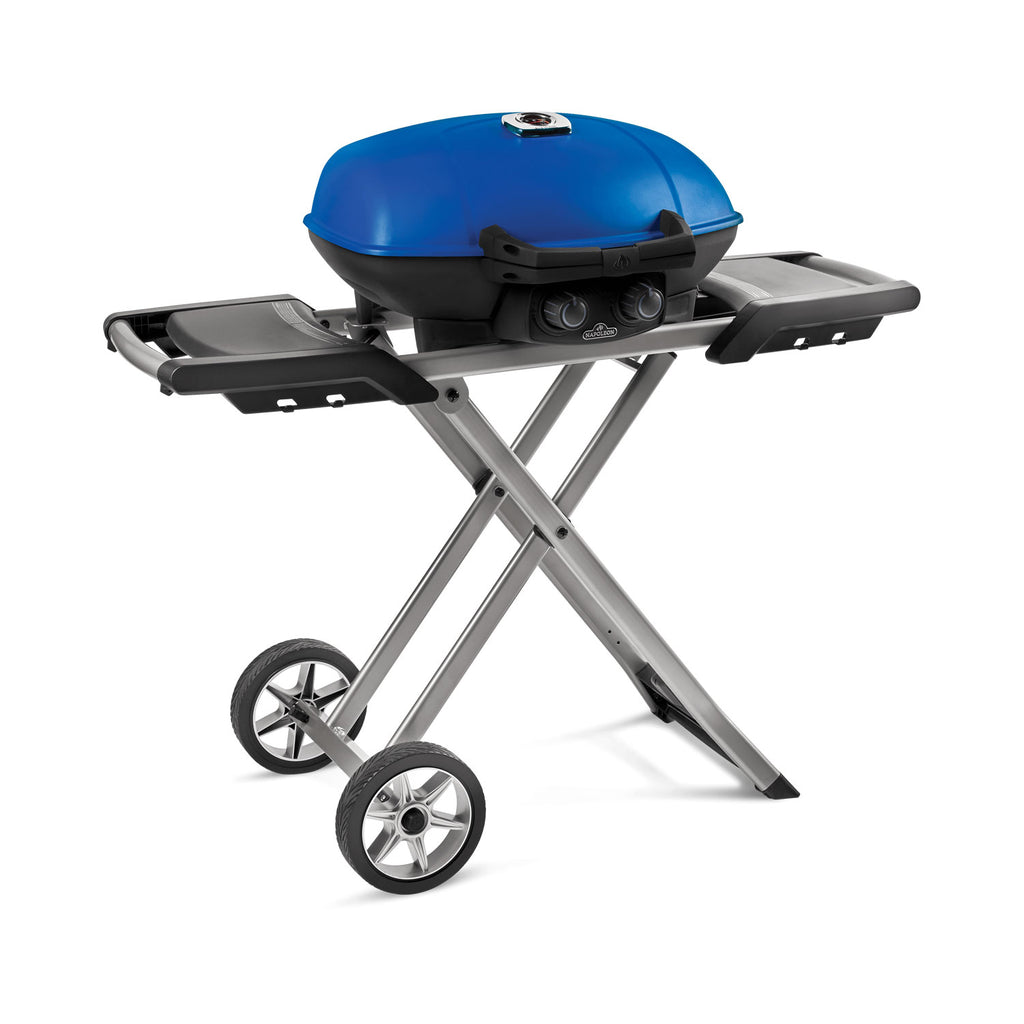 Portable propane grill with blue lid, side shelves, and scissor-cart wheels