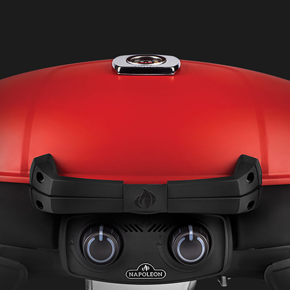 Close-up of red grill lid with black front panel and dual burner control knobs.