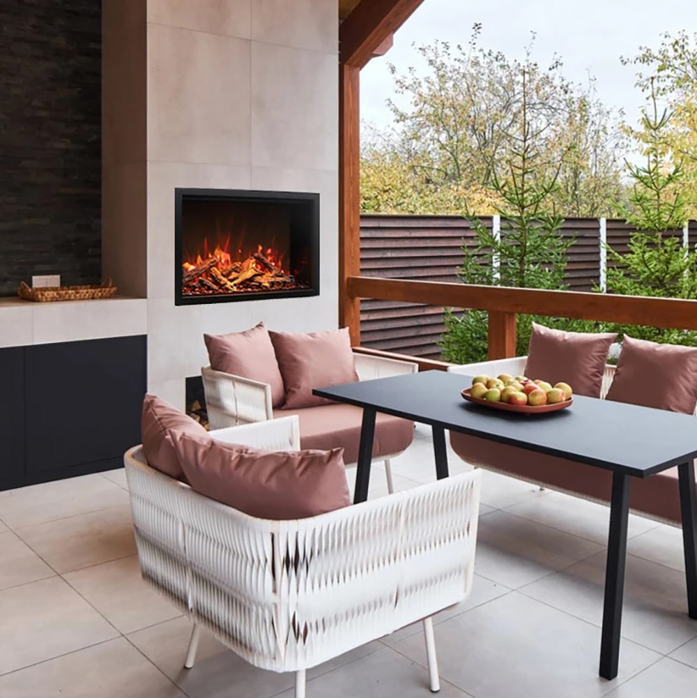 Built-in electric fireplace with dark glass front and orange flame effect in a black frame