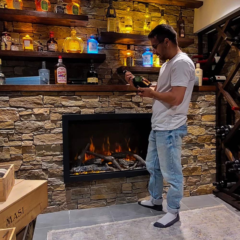Built-in electric fireplace in a stone surround, open firebox with glowing logs and flames
