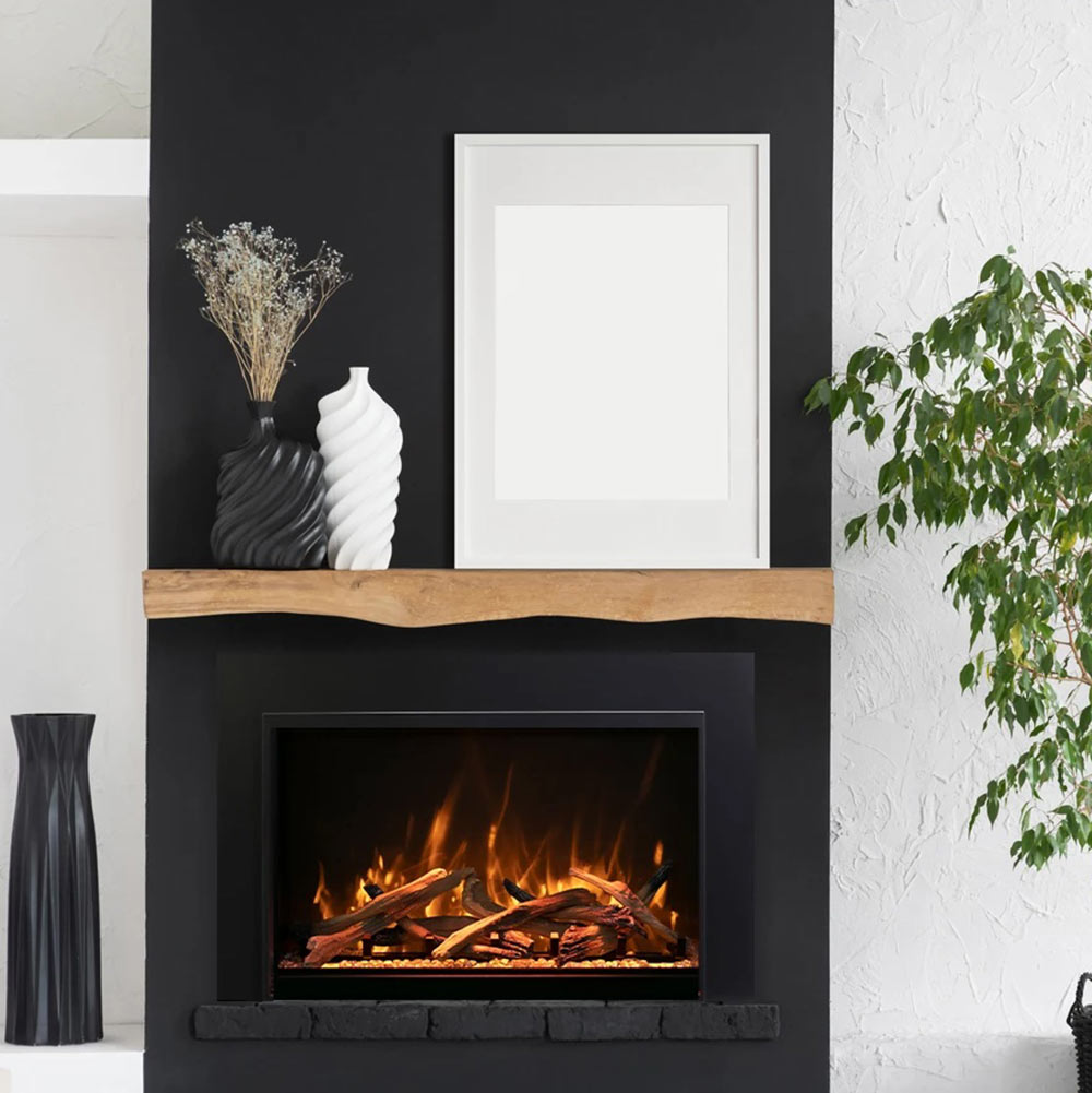 Black electric fireplace insert with burning wood logs and orange flames in rectangular opening