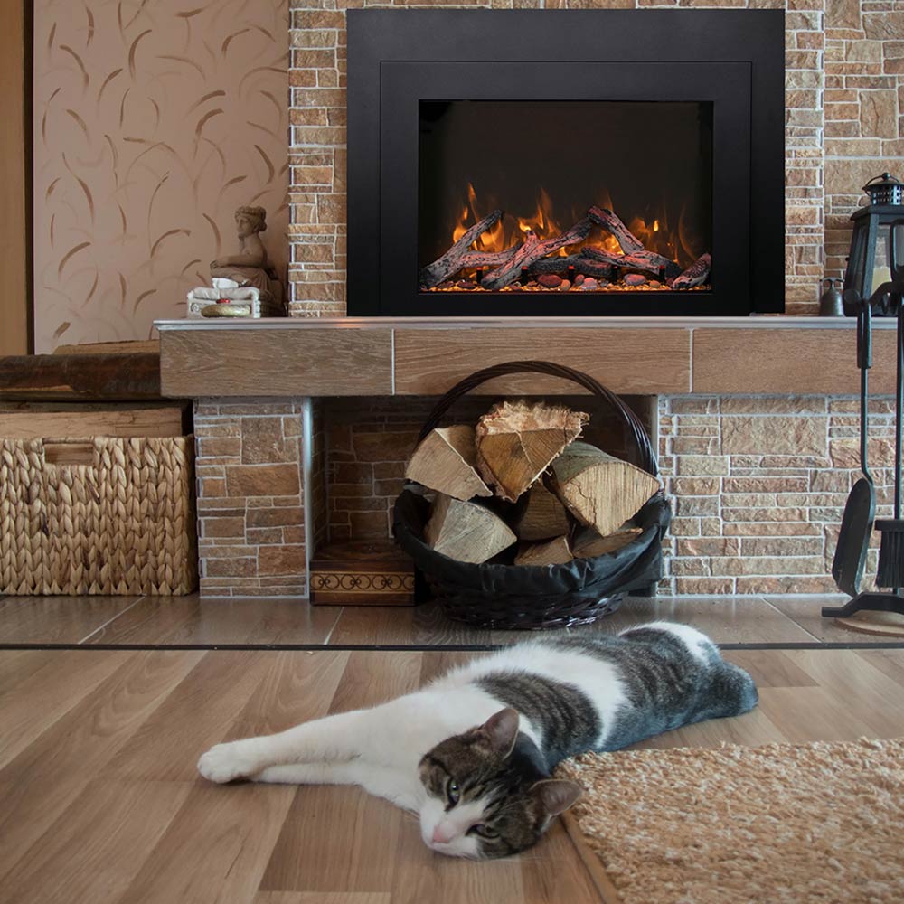 Electric fireplace insert with glowing logs and orange flames in a dark front surround