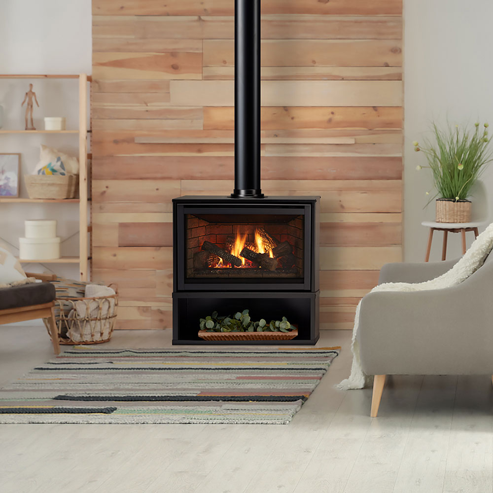 Freestanding gas fireplace unit with black surround and burner flames behind glass