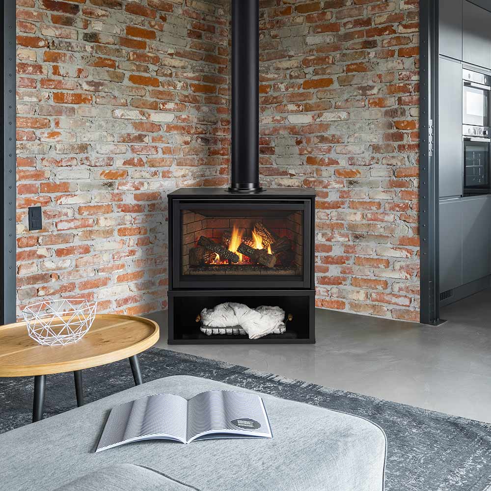 Freestanding gas fireplace with black surround, flame window, and logs on interior
