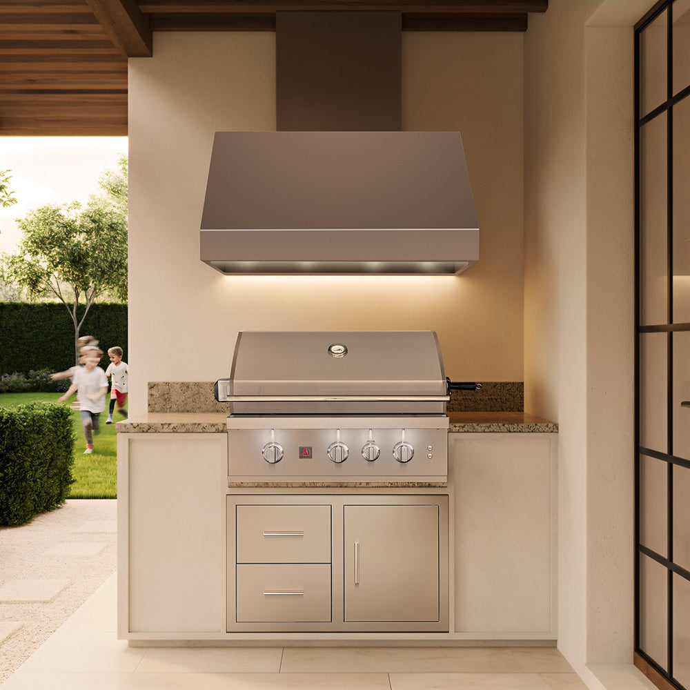 Stainless built-in gas grill installed in an outdoor kitchen cabinet with cabinet doors