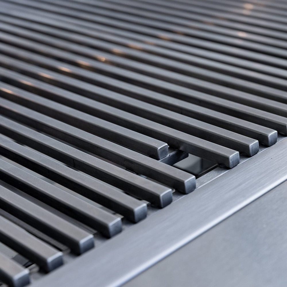 Stainless cooking grates with evenly spaced bars on a built-in gas grill