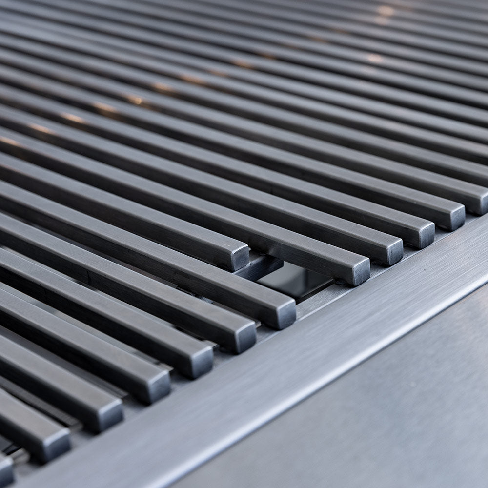 Stainless steel grill grates with dark metal bars, close-up