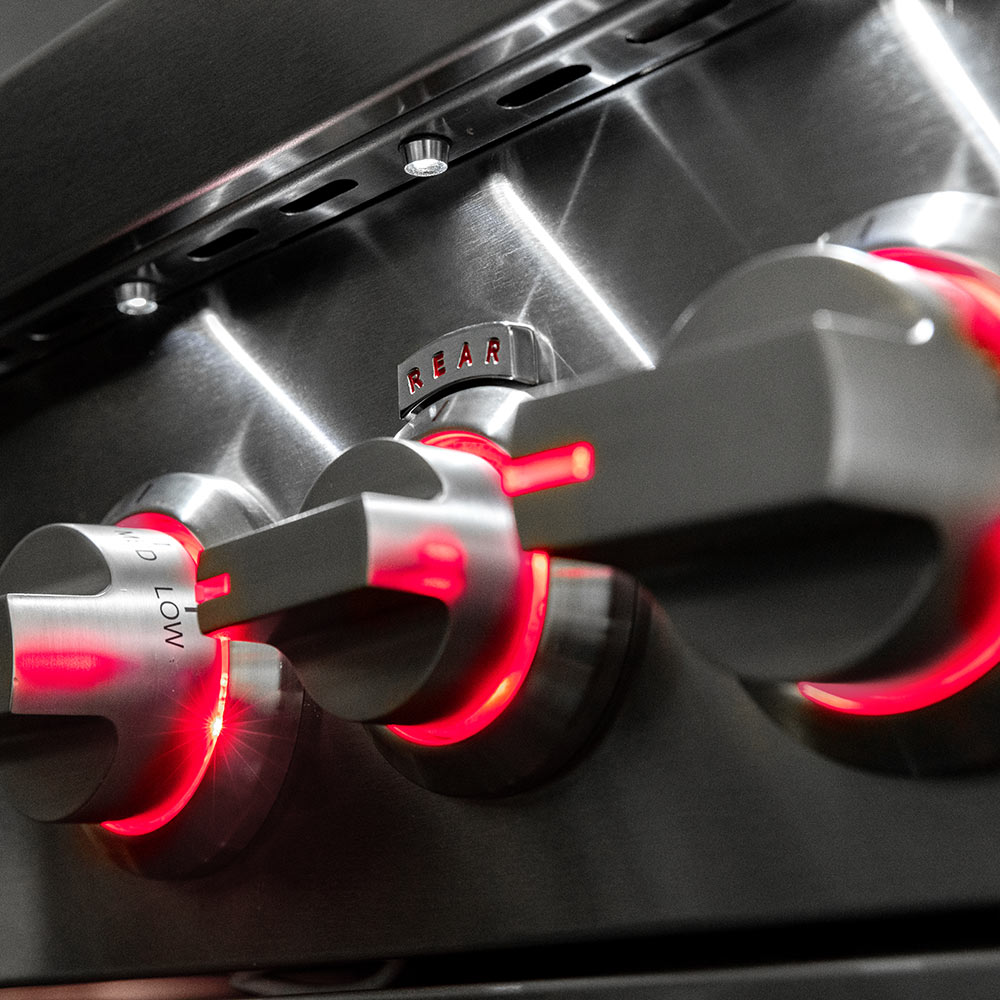 Gas grill control knobs with red indicator lights, stainless control panel