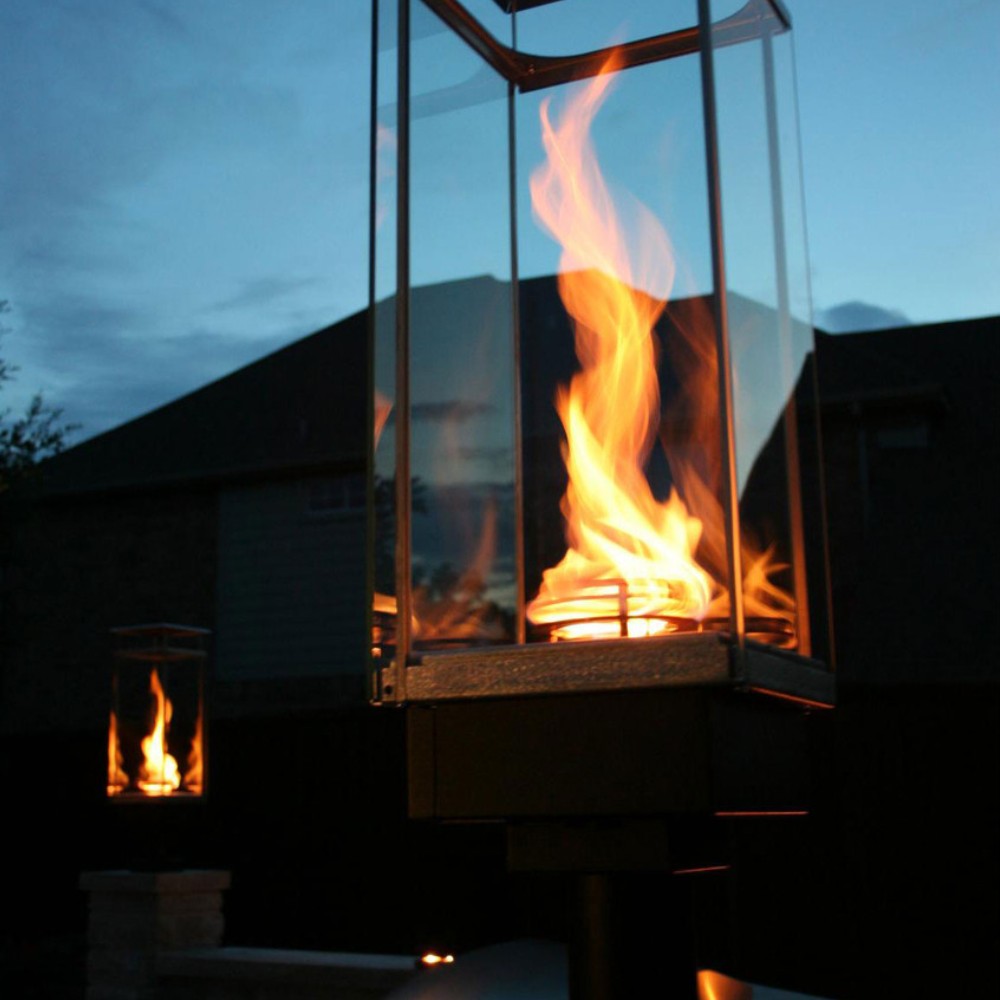 Outdoor gas torch with glass fire chamber and tall burning flame