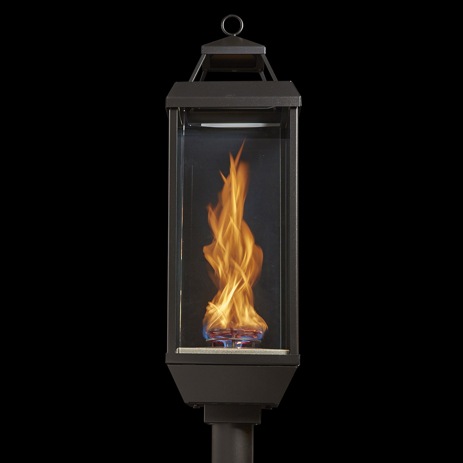 Outdoor gas lantern torch head with burning flame inside clear glass panel and top ring