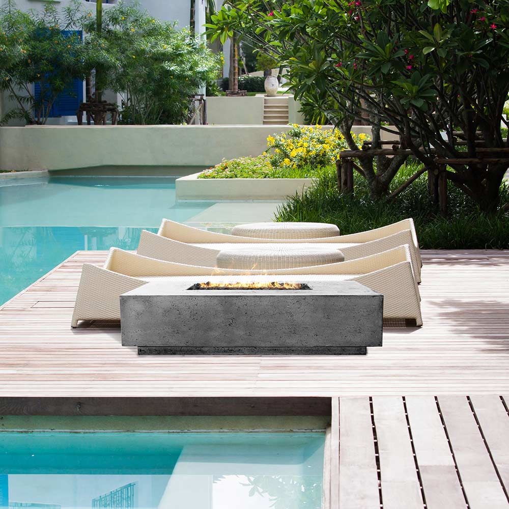 Gray concrete gas fire pit with rectangular burner opening and solid base.
