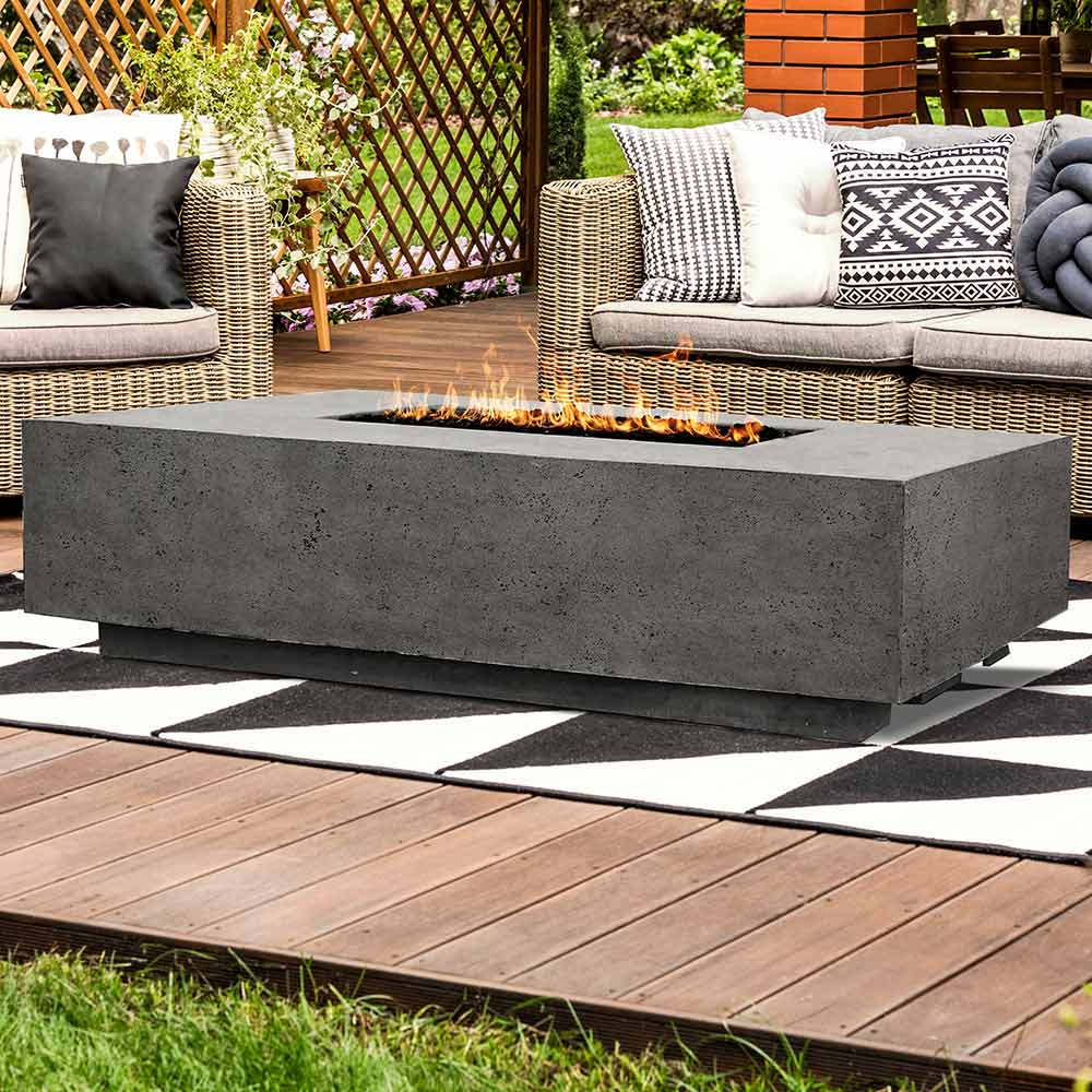 Gray concrete gas fire pit with flames and a rectangular burner opening.