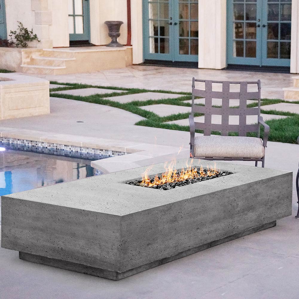 Concrete gas fire pit with rectangular burner opening and visible flames