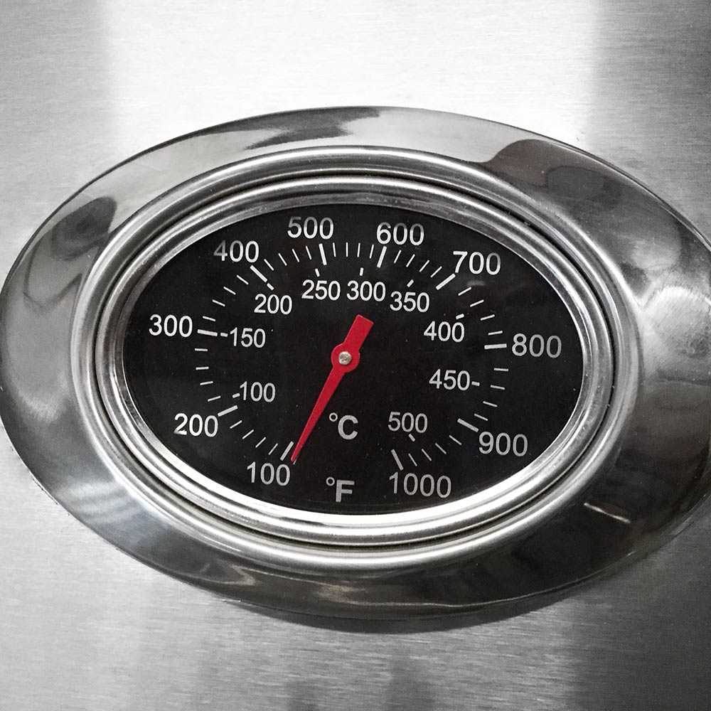 Built-in grill thermometer with temperature scale and red pointer in stainless bezel