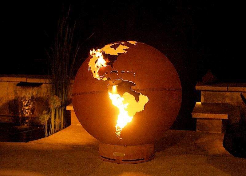 Globe gas fire pit with orange sphere and multiple flames across the continents