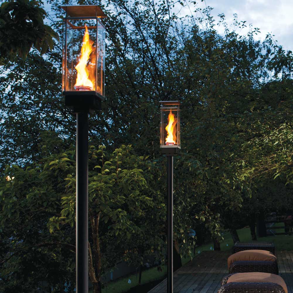 Outdoor gas torch head with in-ground mount, tall black post and flame window