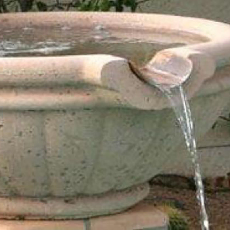 Fire and water bowl with water stream flowing into rounded basin, light gray concrete