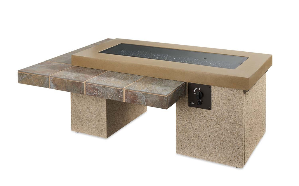 Linear gas fire pit table with tan top, stone-look base, and black control panel.