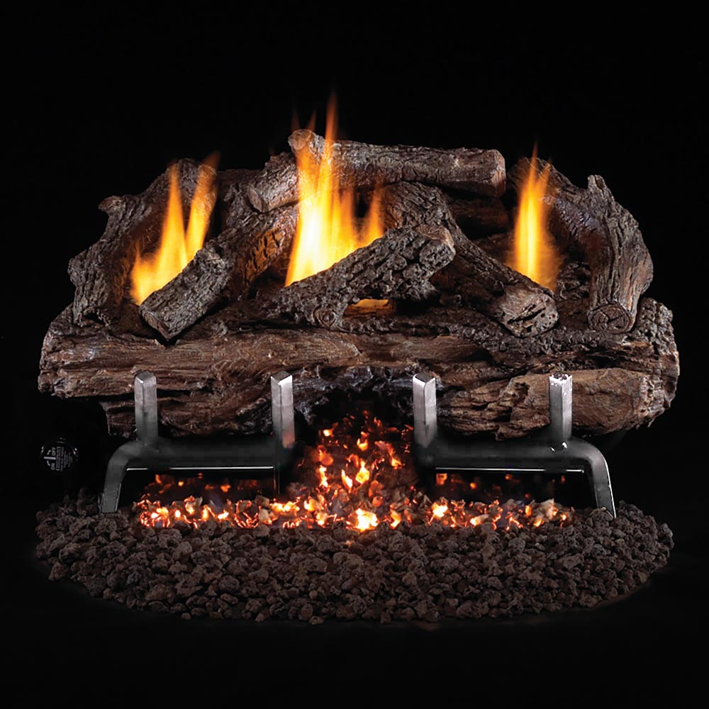 Charred aged gas log set with active flames on a black ember bed and metal burner frame