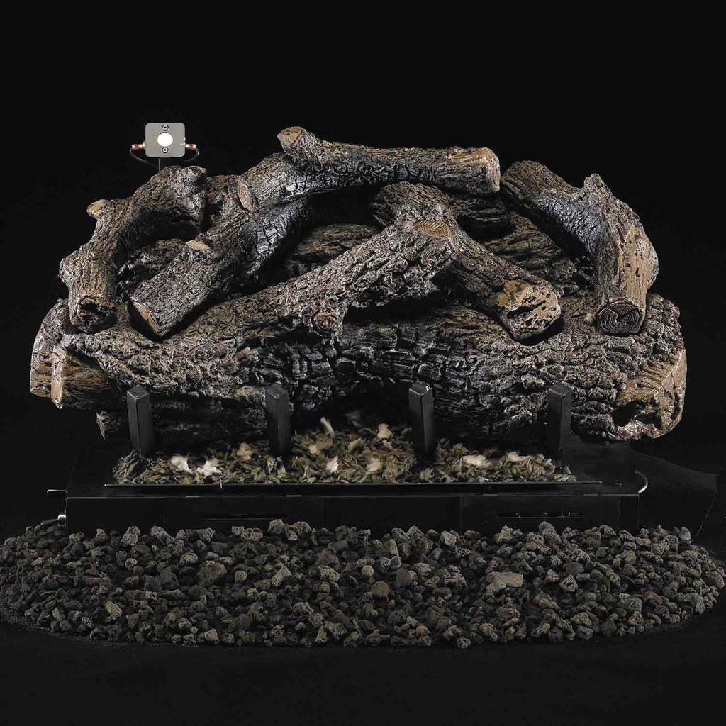 Charred oak gas log set with black burner grate and scattered embers