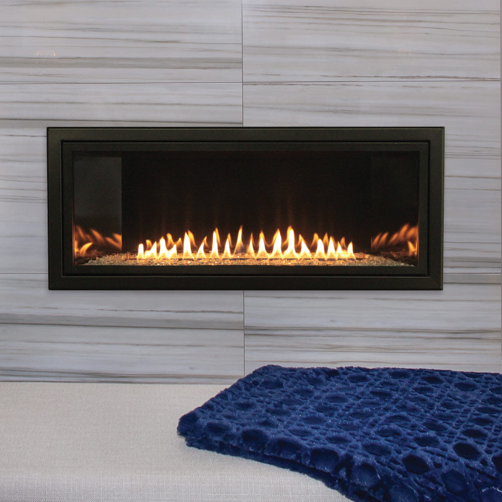 Linear ventless fireplace with dark metal frame, glass front, and visible gas flames