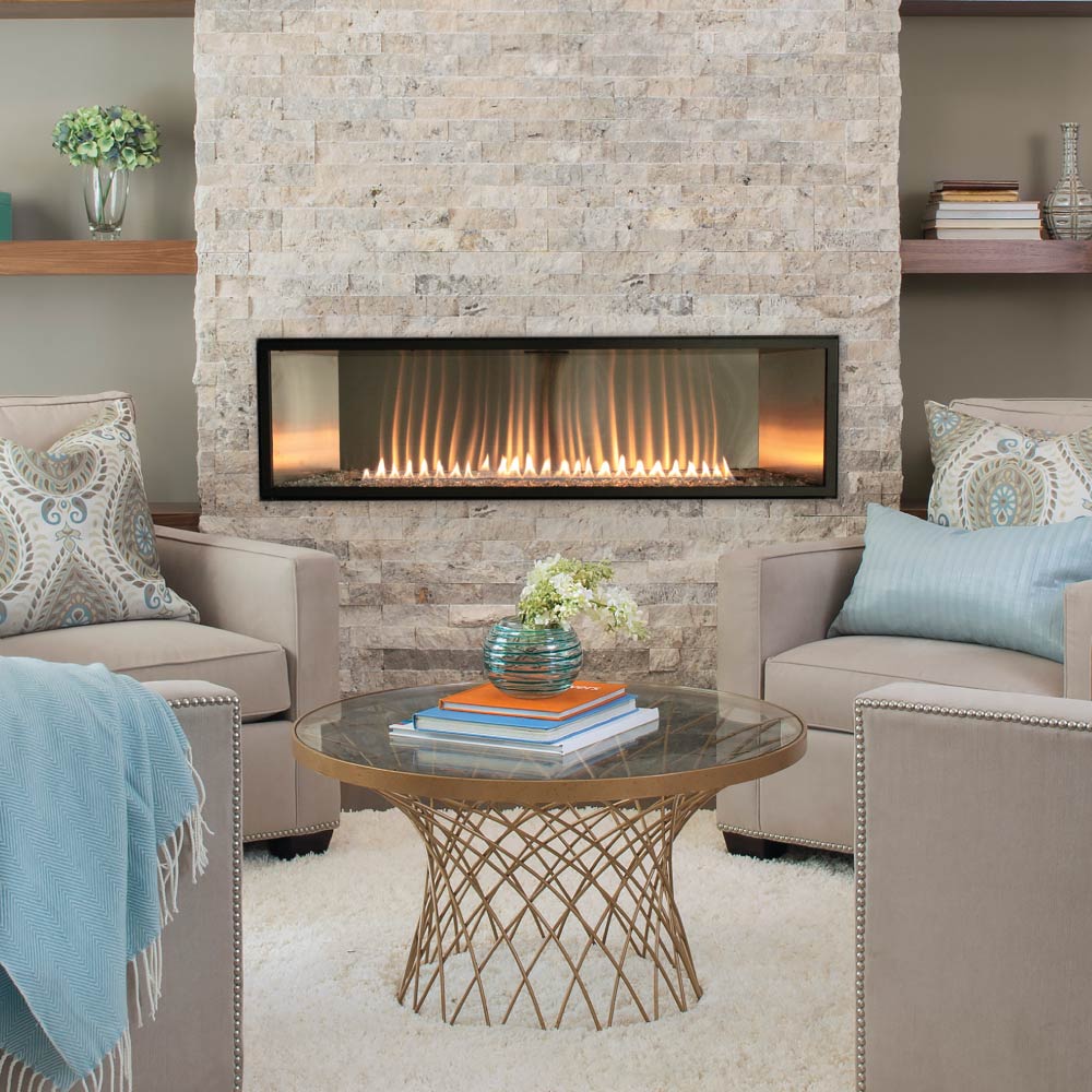 Ventless linear fireplace with glass-front opening and glowing burner in stone surround