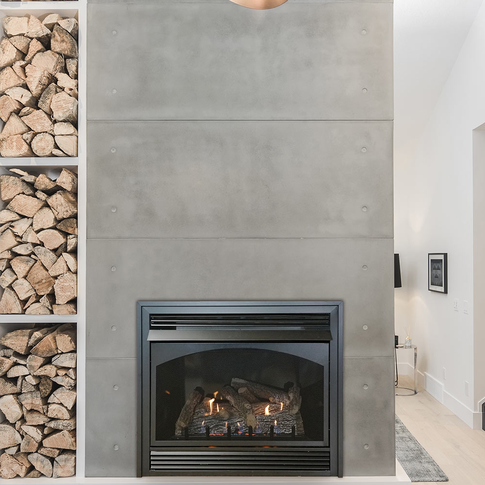 Black ventless fireplace insert with glass front and glowing log set