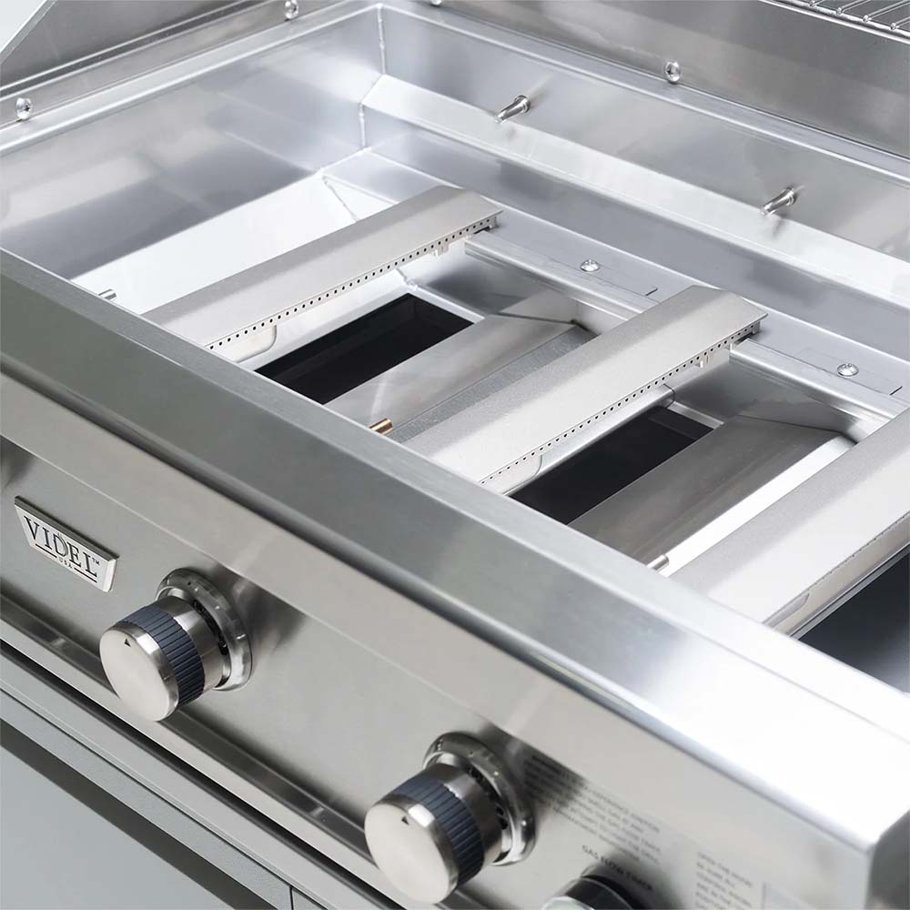 Built-in 3-burner gas grill firebox interior with burner openings and stainless base