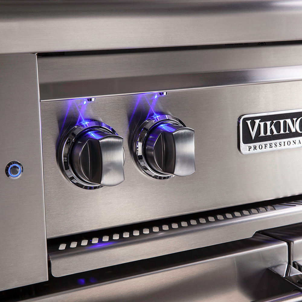 Close-up of Viking professional-grade grill with two control knobs and brand logo.