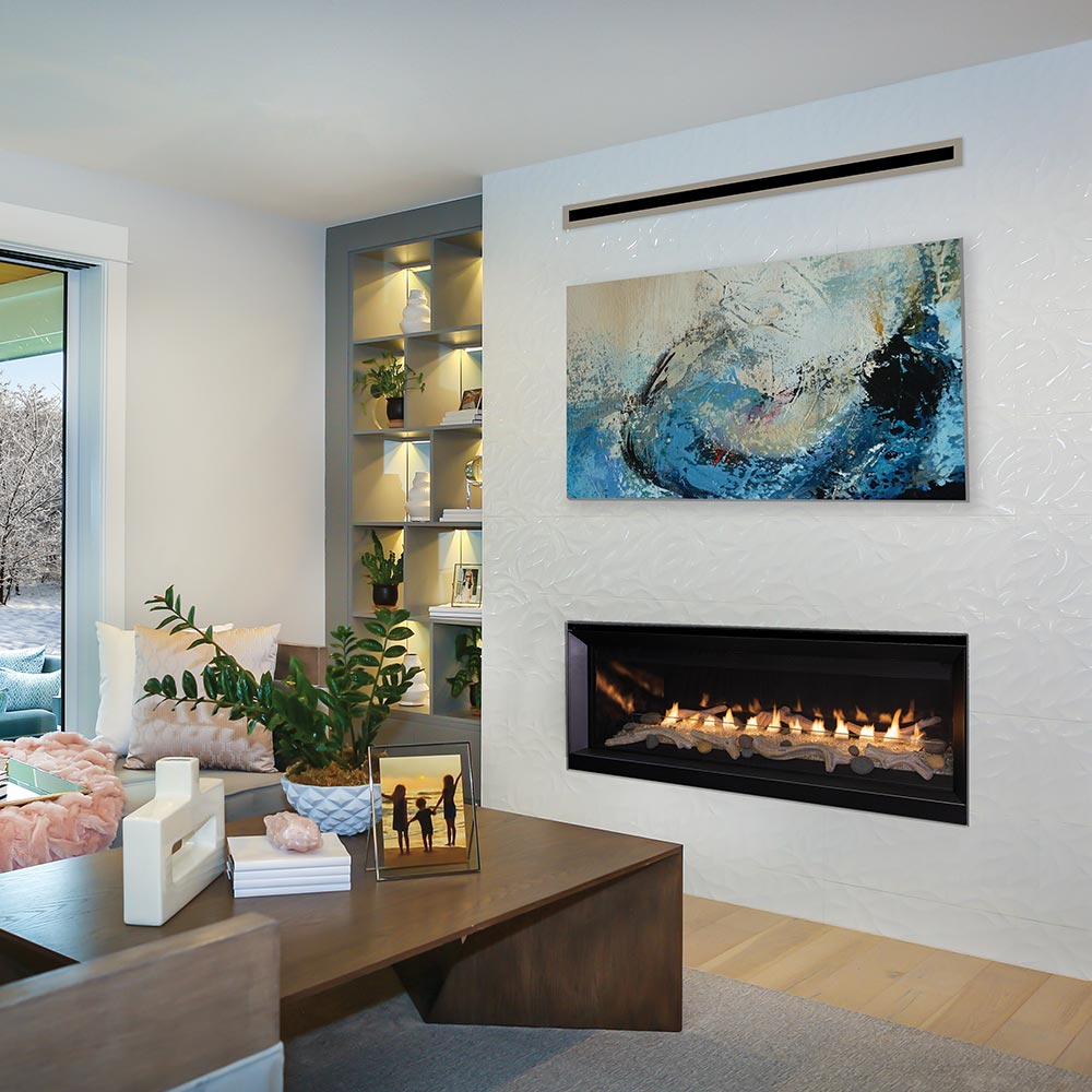 Wall-mounted vent-free gas fireplace with black surround and lit glass media