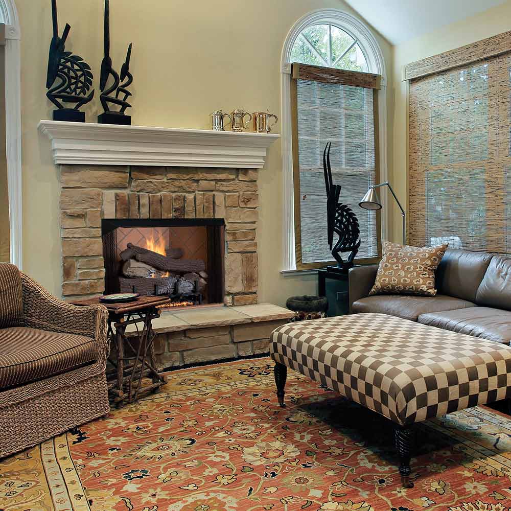 Mosaic masonry firebox with stone tile surround and open firebox opening, light-toned panels